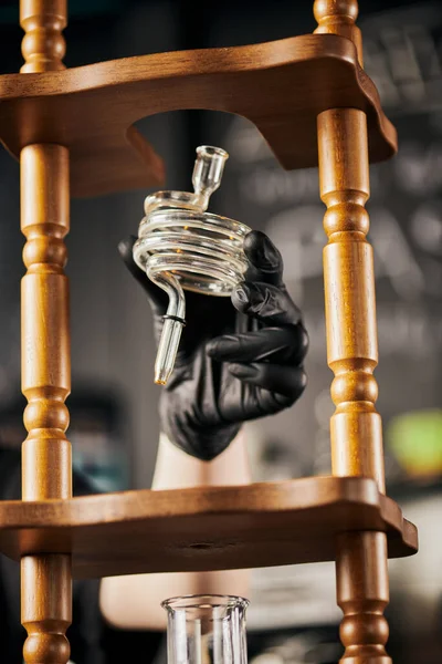 Barista in black glove holding spiral part of cold brew coffee maker, alternative espresso method — Stock Photo