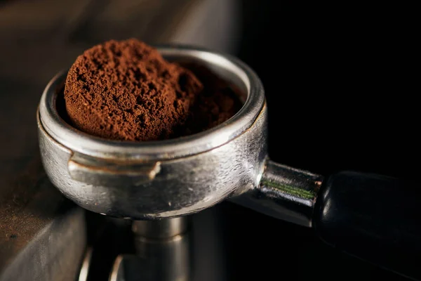 Coffee shop, barista equipment, close up view of portafilter with aromatic ground coffee — Stock Photo