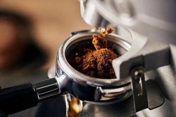 Preparation of espresso, grinded coffee in portafilter, coffee machine, close up, coffee extraction — Stock Photo