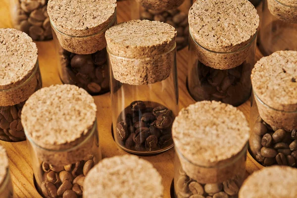 Roasted coffee beans in glass jars with cork, caffeine and energy, arabica, coffee background — Stock Photo