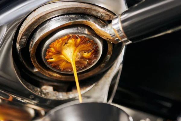 Black coffee, extraction, fresh espresso dripping into cup, professional coffee machine — Stock Photo