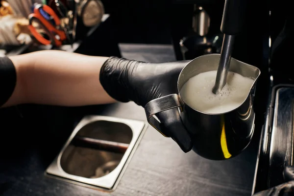 Partial view of barista foaming milk in pitcher, frothing milk, professional coffee machine, latte — Stock Photo