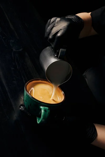 Barista preparing cappuccino, latte art, pitcher with milk, cup with espresso, arabica, energy — Stock Photo