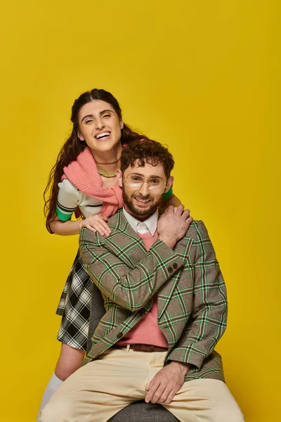 Happy students, cheerful man and woman on yellow backdrop, looking at camera, college outfits — Stock Photo