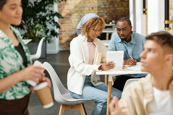 African american coworkers discussing project, using tablet, coworking, start up, generation z, blur — Stock Photo