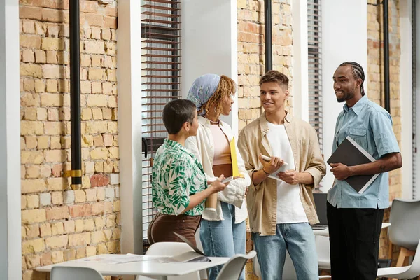 Coworking, young interracial business people discussing startup project in office, generation z — Stock Photo