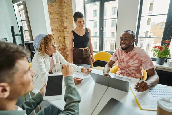 Happy team looking at african man in office, brainstorming, ideas and creativity, startup, business — Stock Photo