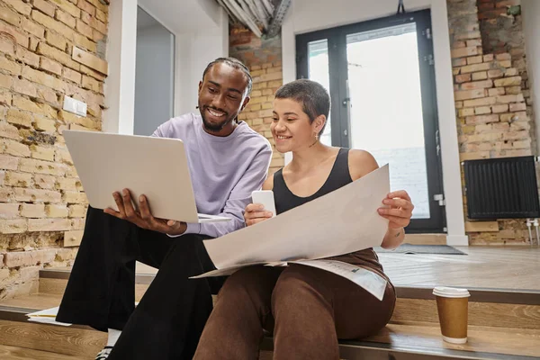 Happy man and woman holding gadgets, discussing project, diverse colleagues, coworking, startup — Stock Photo