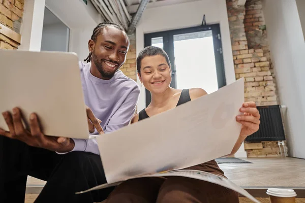 Happy man and woman looking at project on paper, diverse colleagues, coworking, startup, ideas — Stock Photo
