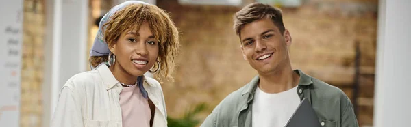 Happy young man smiling next to african american woman in braces, coworking, startup, team, banner — Stock Photo