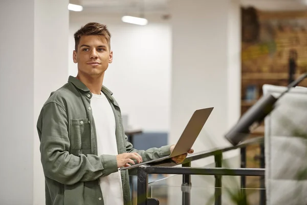 Young businessman using laptop, coworking, modern office, generation z, startup, planning project — Stock Photo