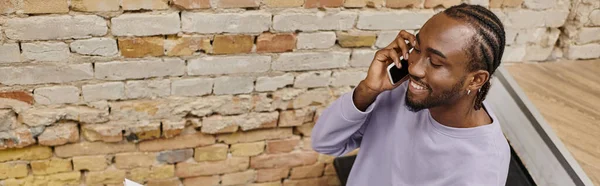 Young african american man talking on smartphone, smiling in coworking, startup, horizontal banner — Stock Photo