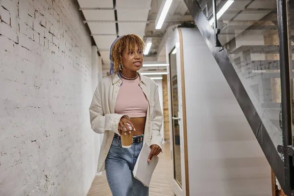 Young african american woman with braces holding papers and coffee to go, startup project, gen z — Stock Photo