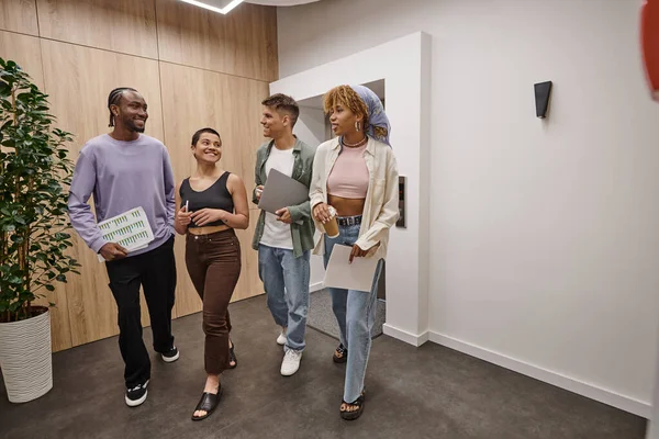 Cultural diversity, happy interracial colleagues walking together in modern coworking, startup — Stock Photo