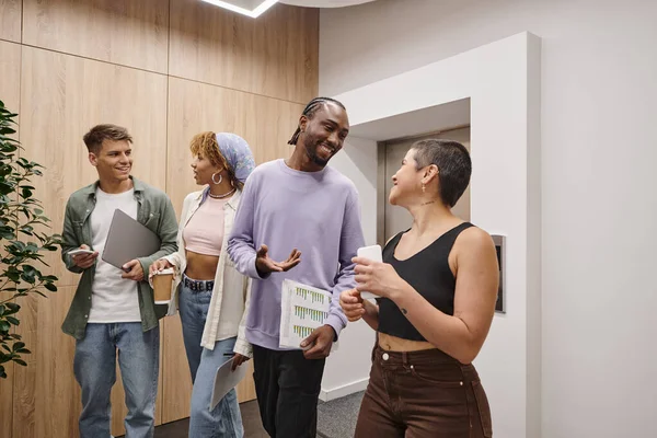 Tattoo: no sugar, happy interracial business people chatting in hallway, coworking, startup, young — Stock Photo