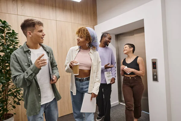 Diversité culturelle, heureux interracial hommes et femmes bavarder dans le couloir, coworking moderne, démarrage — Photo de stock