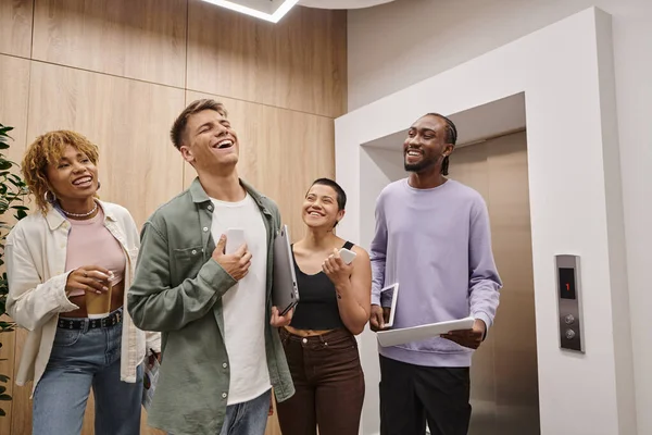 Diversity, happy business people laughing and holding gadgets, coworking, startup, generation z — Stock Photo