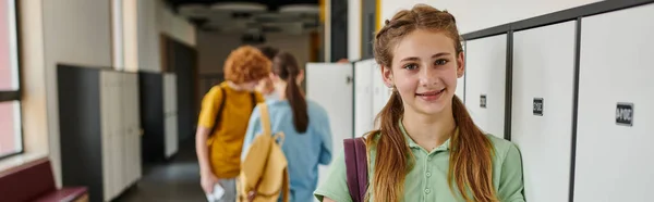 Banner, positive teen girl looking at camera in school hallway, happy face, back to school concept — Stock Photo