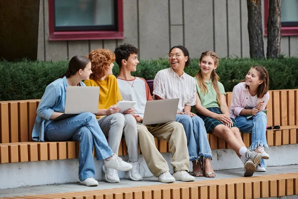 Back to school, teen students with gadgets talking to african american teacher, diversity, education — Stock Photo