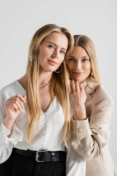 Portrait of two stylish attractive sisters hugging and looking at camera, bonding, fashion concept — Stock Photo