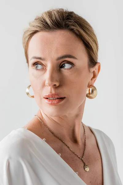 Portrait of stylish blonde woman with golden earrings and formal attire looking aside, fashion — Stock Photo