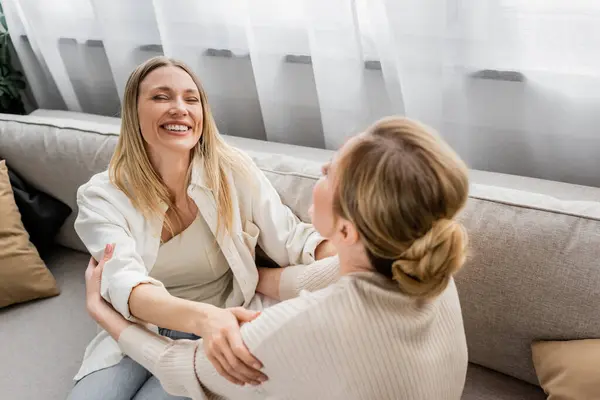 Lovely pretty sisters in trendy wear laughing and looking at each other, hand on shoulder, bonding — Stock Photo