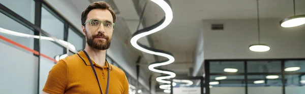 Entrepreneur à barbe réussie dans les lunettes de vue regardant la caméra dans l'espace de bureau — Photo de stock