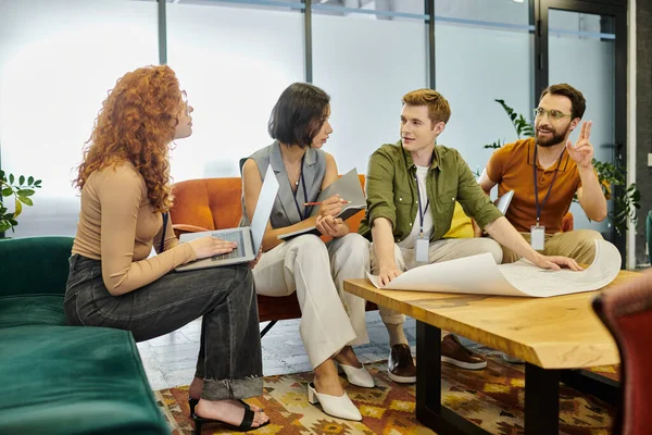 Startup project, business team with laptop and documents talking near blueprint on table in office — Stock Photo