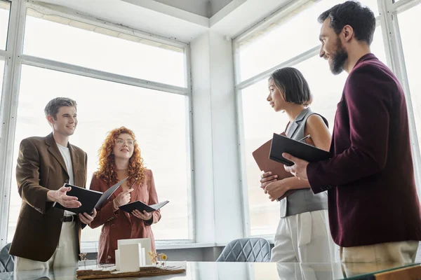 Young architects showing architectural project to business partners in office, startup concept — Stock Photo
