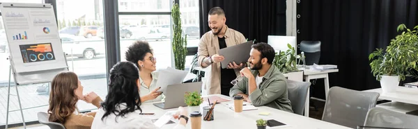 Happy interracial business team discussing project and sharing ideas in modern coworking, banner — Stock Photo