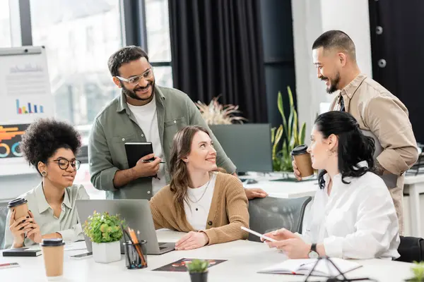 Startup ideas, interracial business team discussing project and sharing ideas in modern coworking — Stock Photo