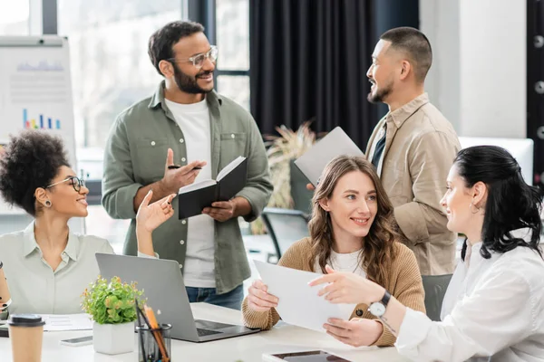 Happy multiethnic business team generating ideas and discussing startup project in coworking — Stock Photo