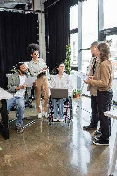Diversity and inclusion, happy interracial team planning startup project with woman in wheelchair — Stock Photo