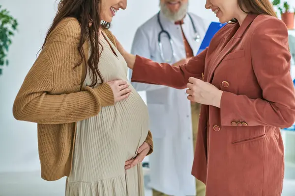 Ausgeschnittene Ansicht eines Arztes, der neben einer schwangeren lesbischen Frau mit ihrem Partner steht, ivf concept — Stockfoto
