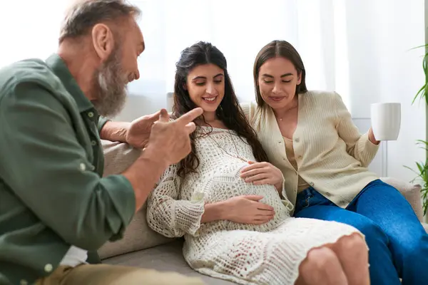 Cheerful father paid visit to his lesbian daughter and her partner, drinking tea, ivf concept — Stock Photo