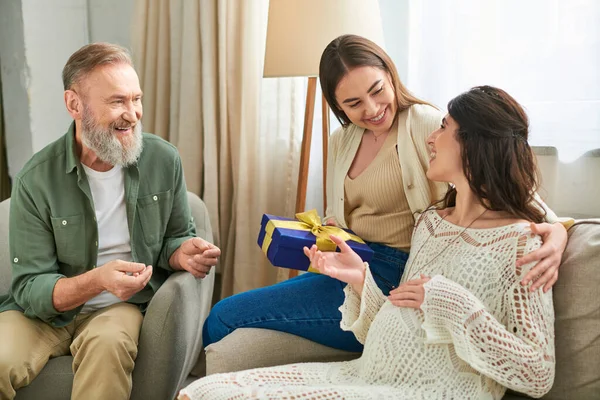 Happy beautiful couple enjoying gift smiling sincerely and looking at each other, ivf concept — Stock Photo