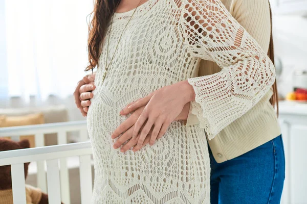 Cropped view of young lesbian couple hugging warmly with hands on pregnant belly, ivf concept — Stock Photo