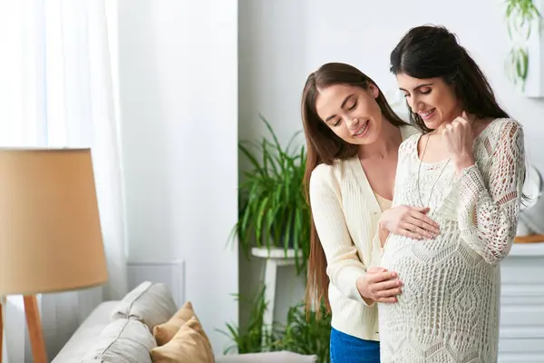 Joyous lgbt couple hugging smiling and looking at pregnant belly, in vitro fertilisation concept — Stock Photo
