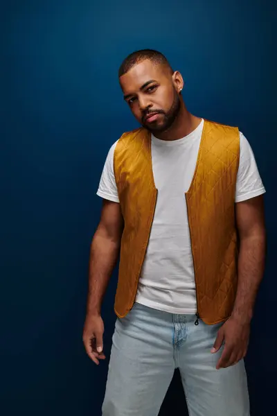 Stylish bearded african american man wearing yellow vest looking at camera, fashion concept — Stock Photo