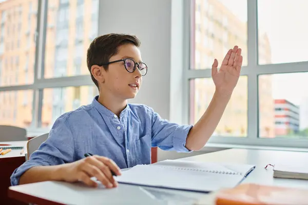 A young man with his hand up, actively engaging students in a bright, lively classroom setting. — Stock Photo
