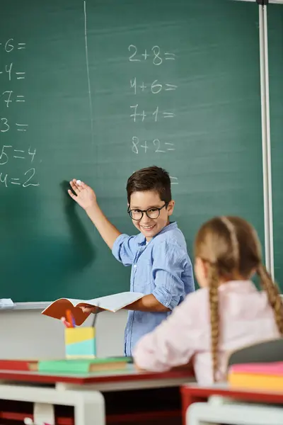 A boy and a girl stand in front of a blackboard in a bright, lively classroom setting. — Stock Photo