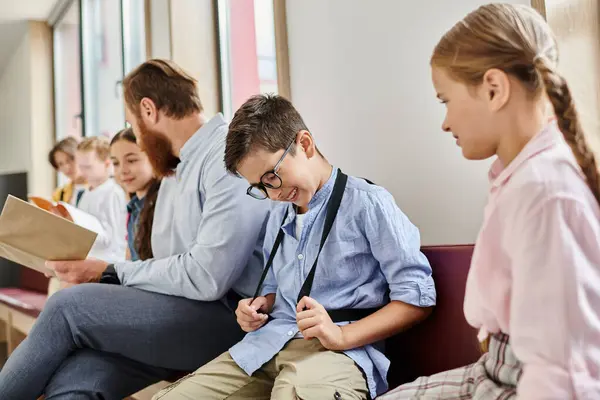 In a bright, lively classroom, a man teacher instructs a diverse group of kids who are sitting next to each other attentively. — Stock Photo