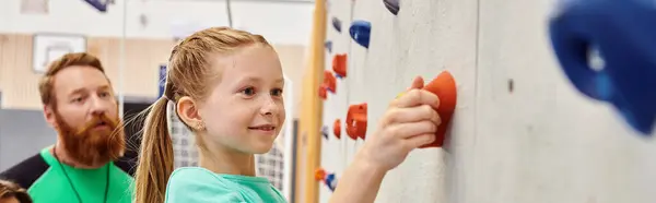 Un uomo e una bambina stanno fianco a fianco, arrampicandosi sulla parete — Foto stock