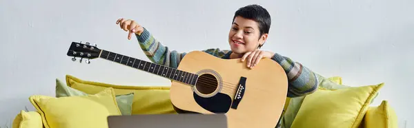 Young jolly woman in casual attire learning how to play guitar on remote class, education, banner — Stock Photo
