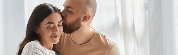 Happy man hugging his beautiful wife and kissing her lovingly in forehead, family concept, banner — Stock Photo