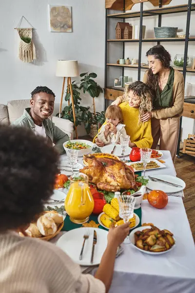 Concepto de celebración de Acción de Gracias, amigos interracial teniendo una cena festiva con pareja lgbt - foto de stock
