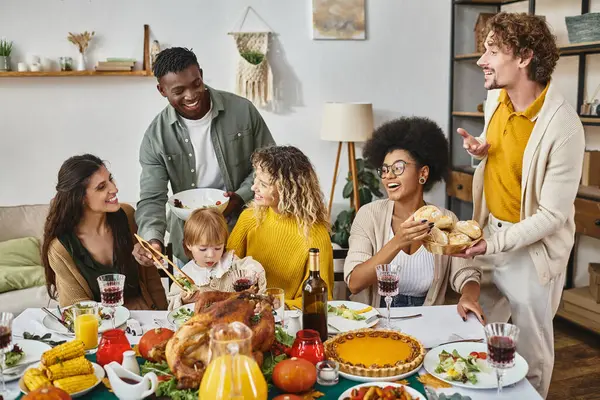 Thanksgiving feast, happy multiethnic friends and family gathering at festive table with turkey — Stock Photo