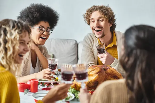 Membros da família multicultural feliz rindo de mesa festiva e copos de vinho clinking, Natal — Fotografia de Stock