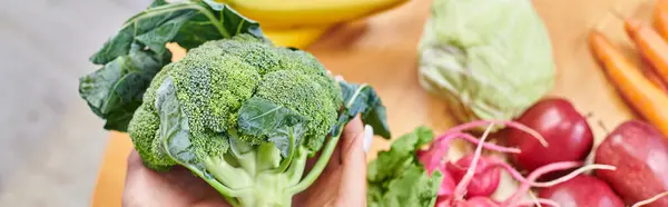 Top view of vegetarian woman with broccoli over fresh fruits and vegetables, horizontal banner — Stock Photo