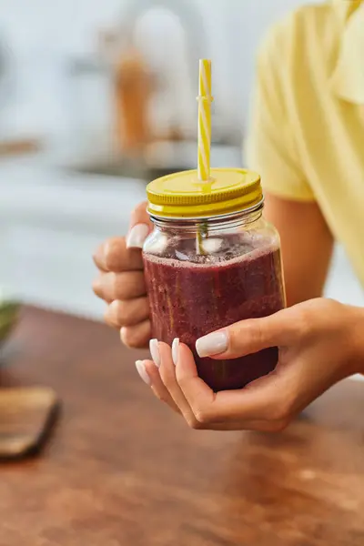 Cropped view of woman with refreshing smoothie in mason jar with straw, plant-based diet concept — Stock Photo